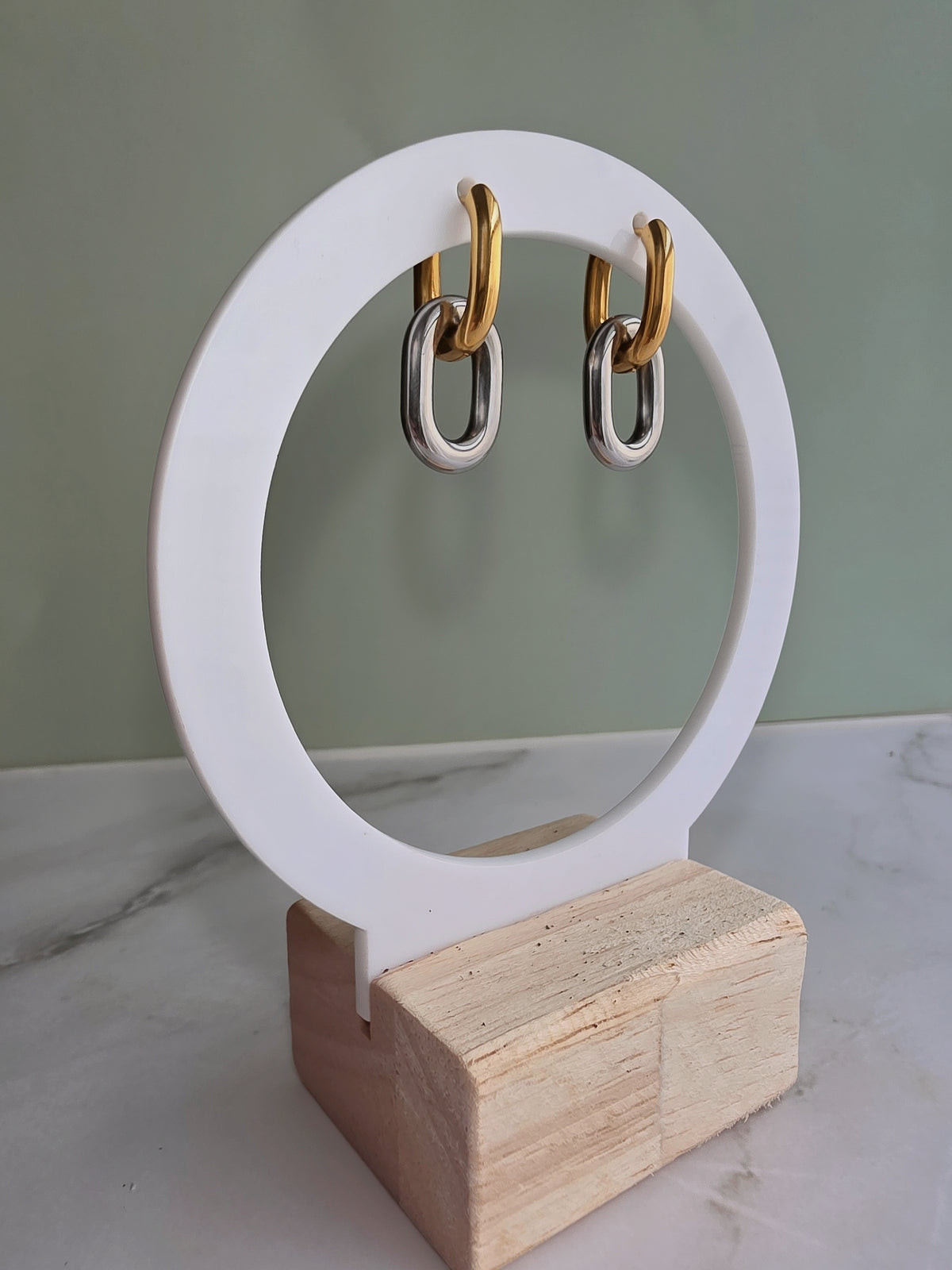 Mixed metal earrings crafted from stainless steel in gold and silver.