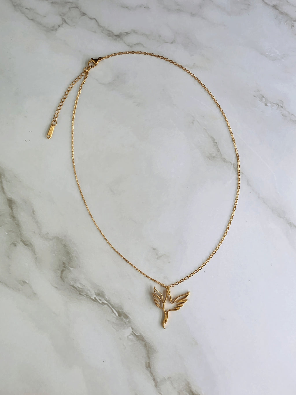Elegant phoenix pendant necklace in gold and silver stainless steel finishes.