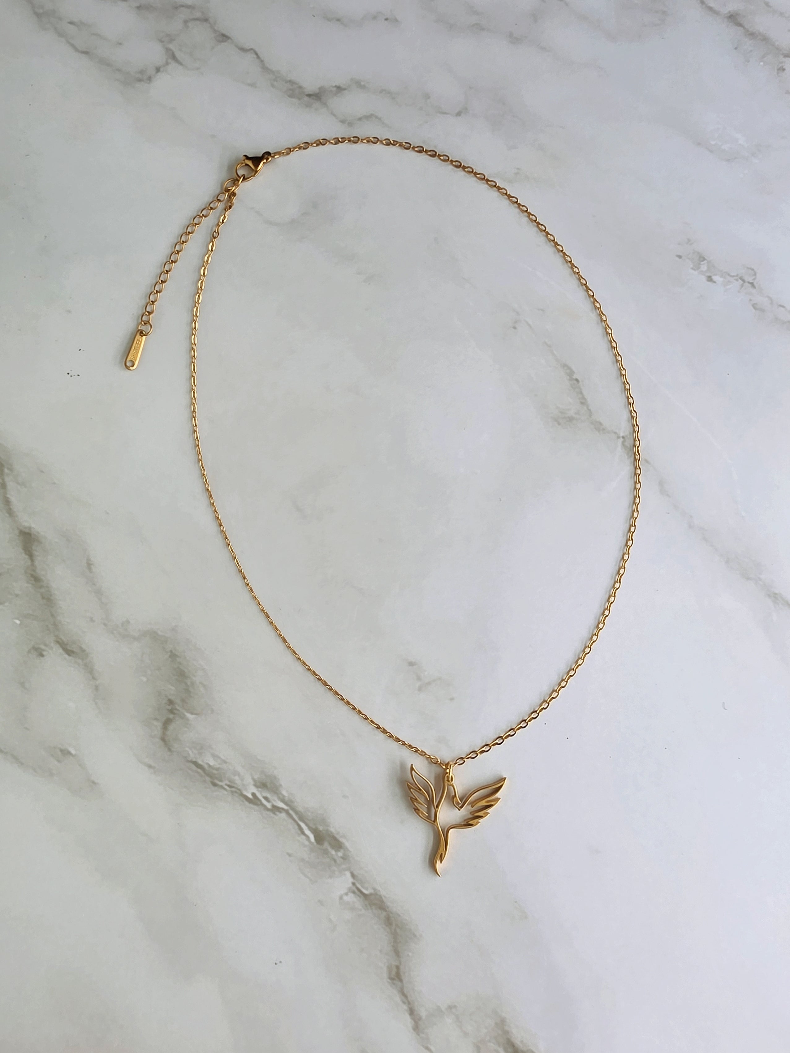 Elegant phoenix pendant necklace in gold and silver stainless steel finishes.