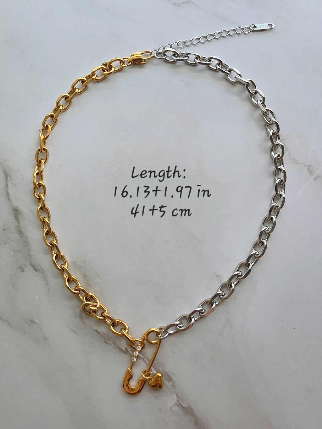 Two-tone safety pin necklace and bracelet set for everyday wear.