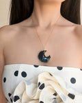 Obsidian crescent moon necklace with an 18K gold-plated finish.