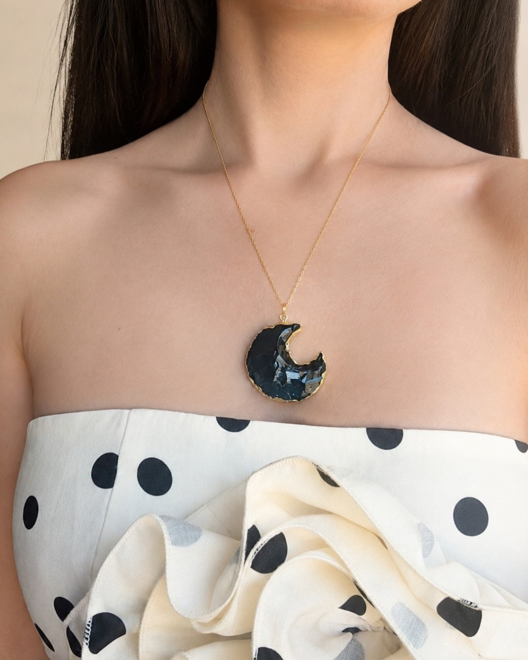 Obsidian crescent moon necklace with an 18K gold-plated finish.
