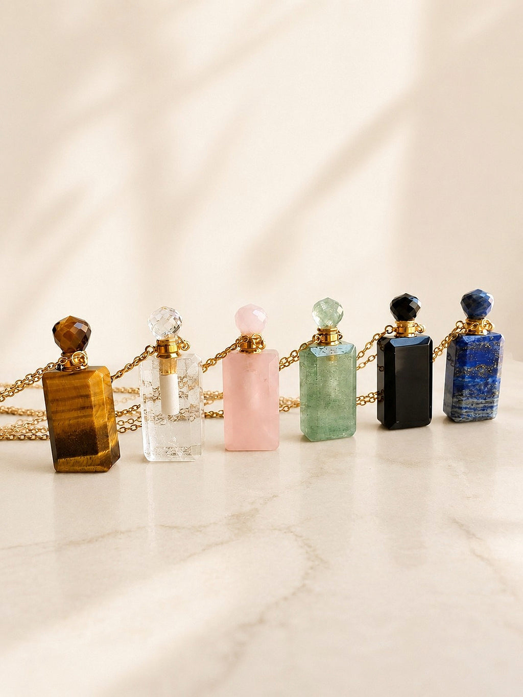 Crystal perfume bottle necklace with a refillable gemstone vial.