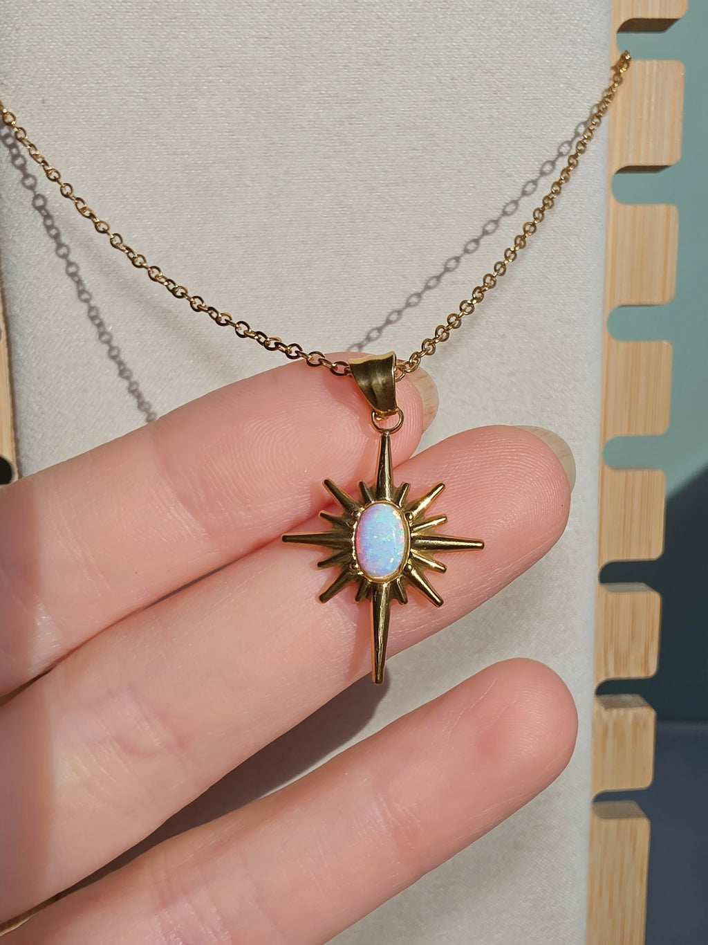 Minimalist celestial necklace featuring an opal star pendant.