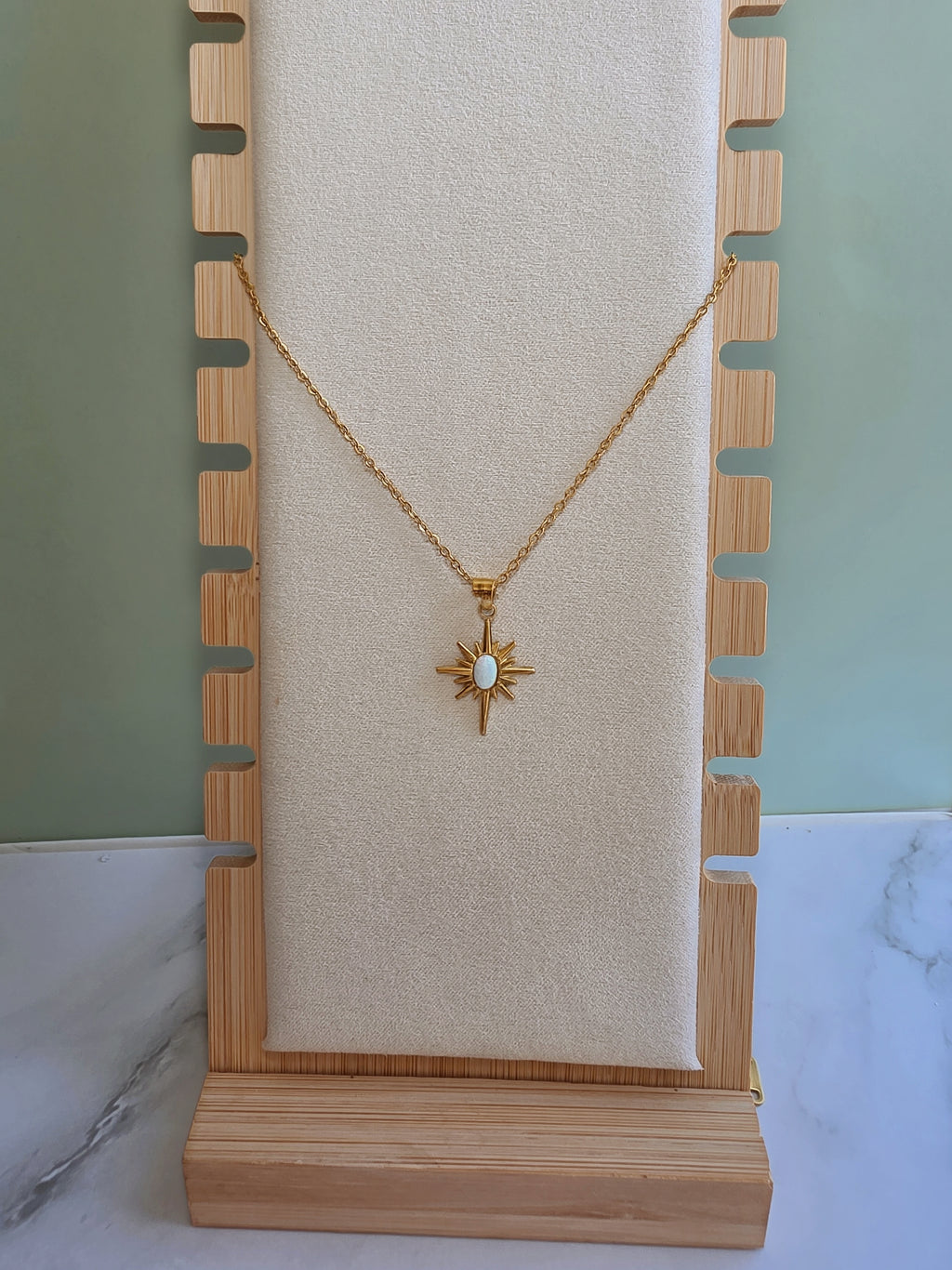 Non tarnish North Star necklace with a luminous opal centerpiece.
