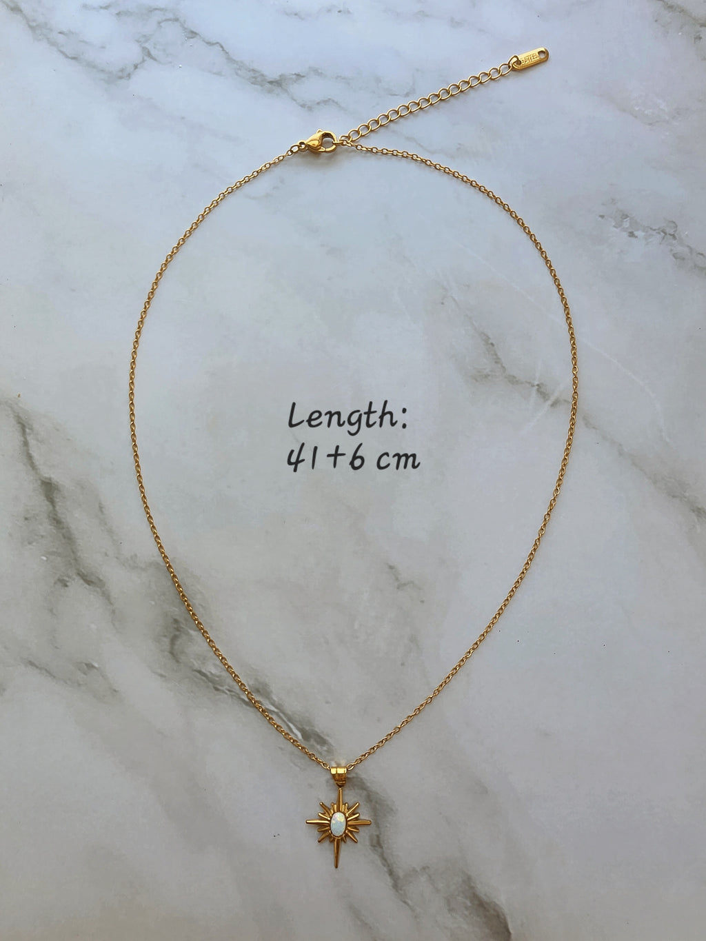 Layered opal North Star necklace in gold.