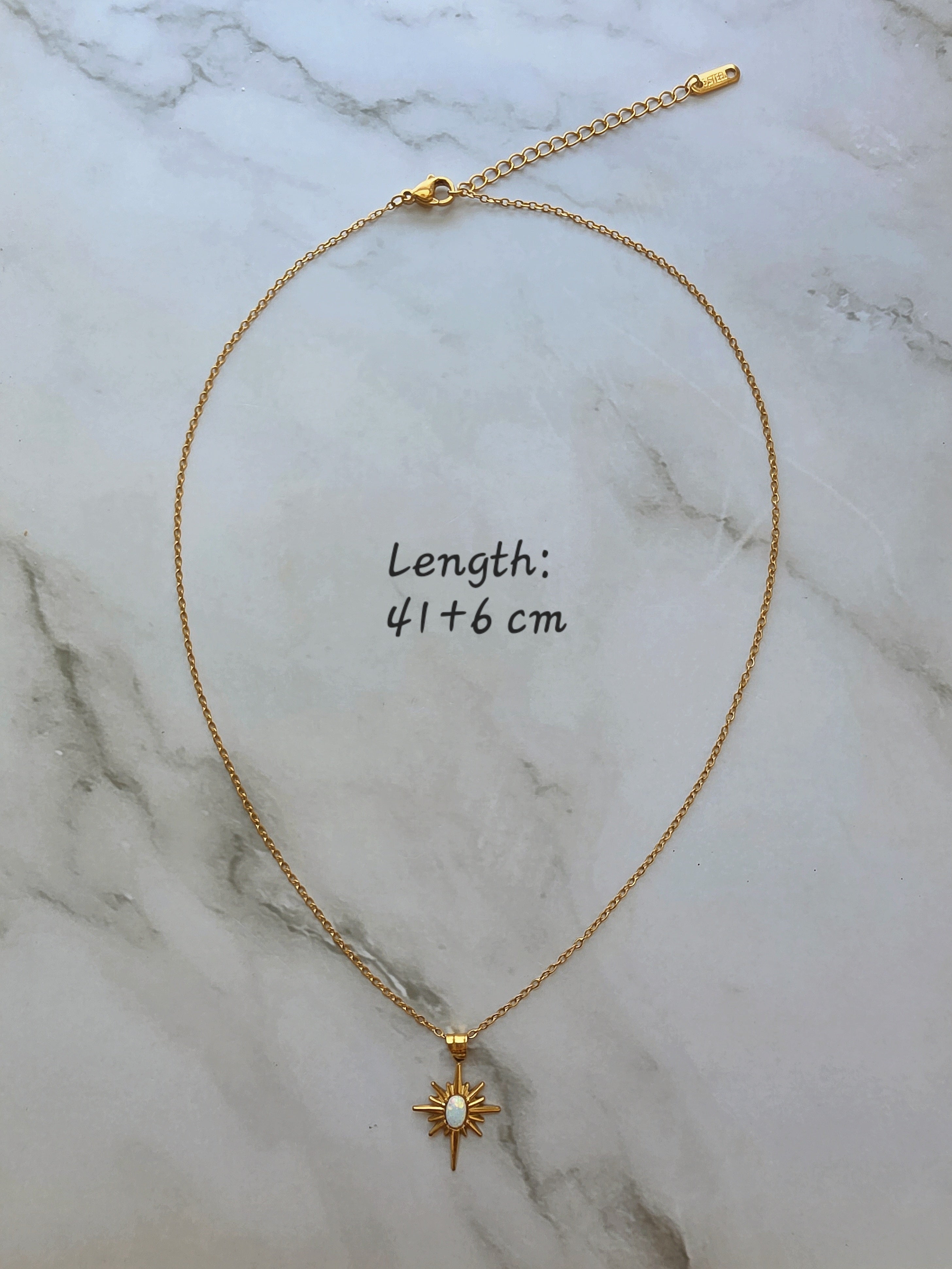 Layered opal North Star necklace in gold.