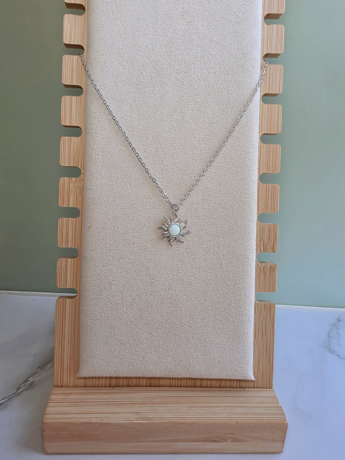 Silver Opal Sun necklace with a celestial design.