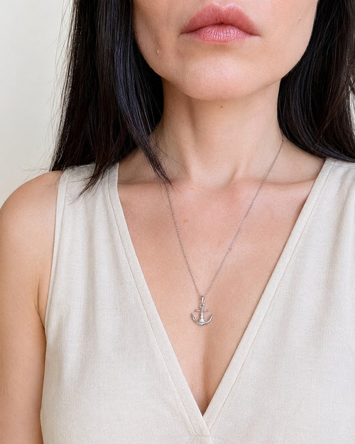Nautical anchor necklace in gold and silver finishes.