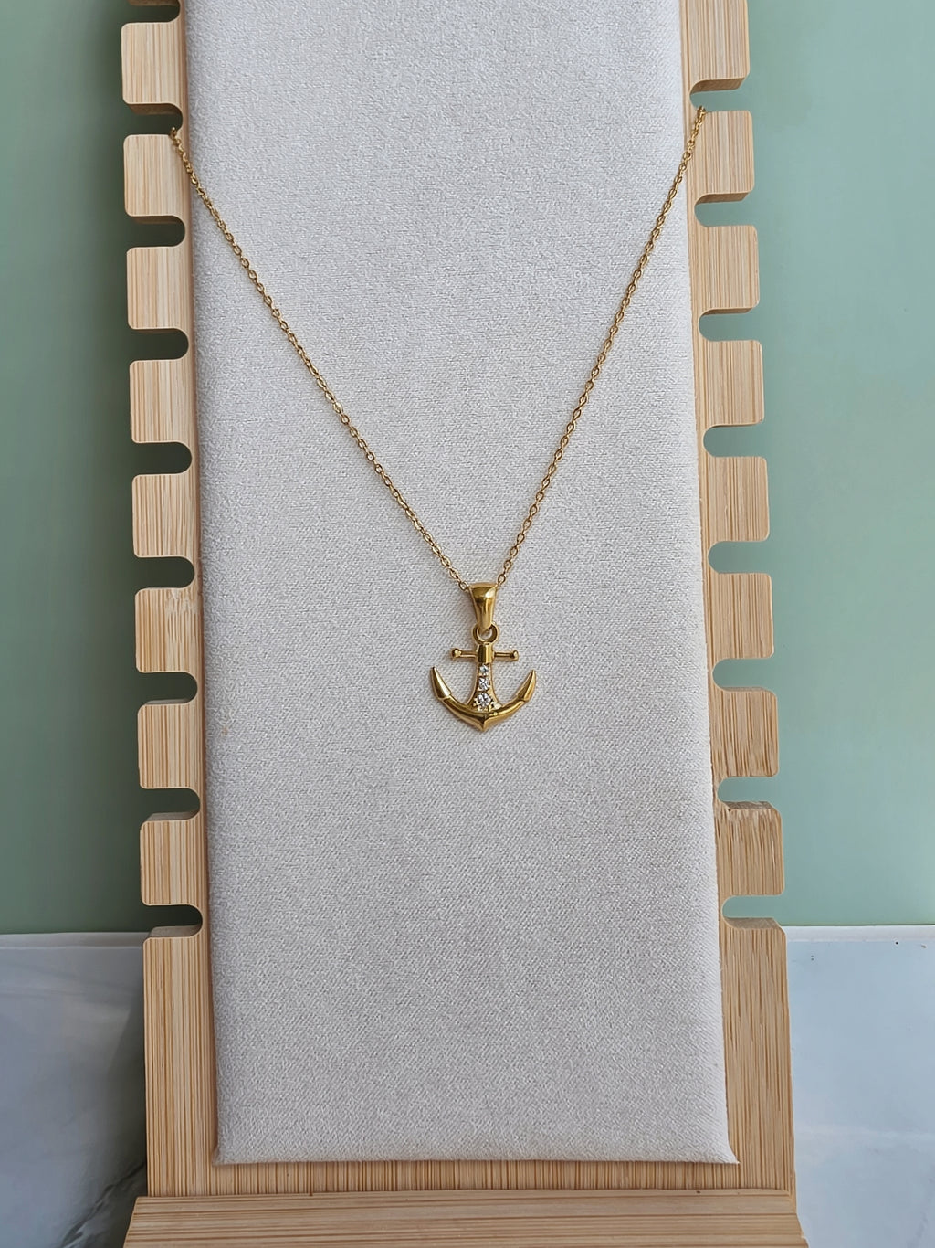 Gold anchor necklace for everyday wear.