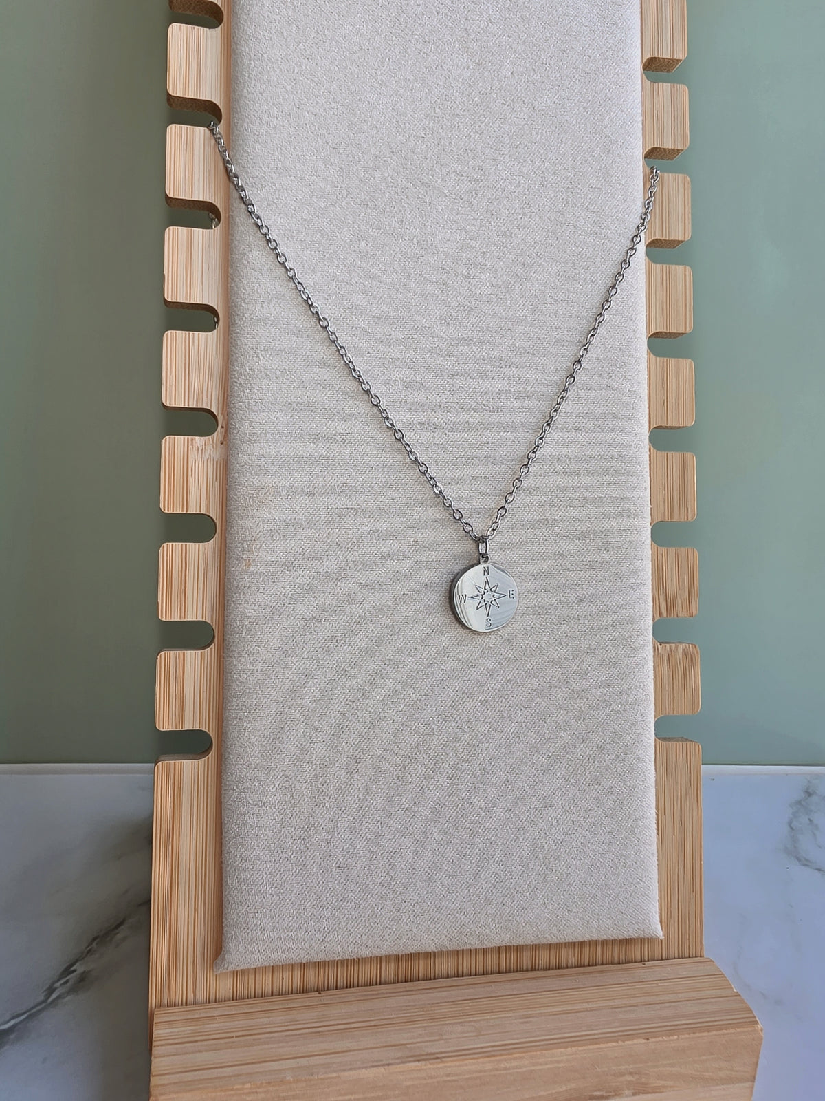 North Star compass necklace with round engraved charm.