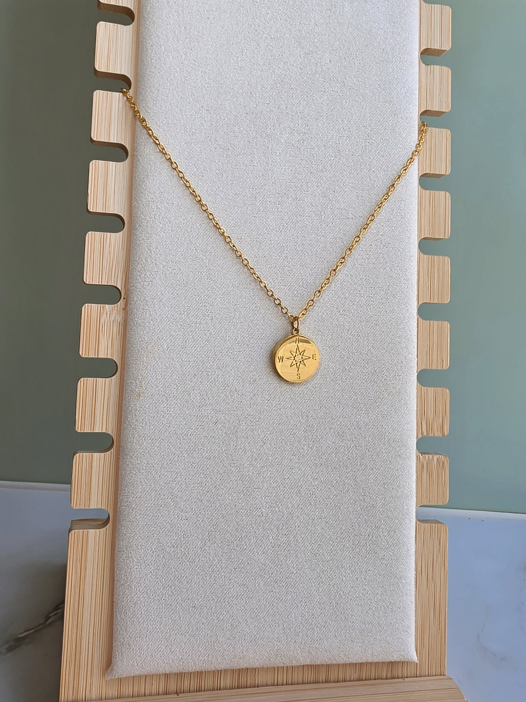 North Star compass necklace symbolizing guidance.