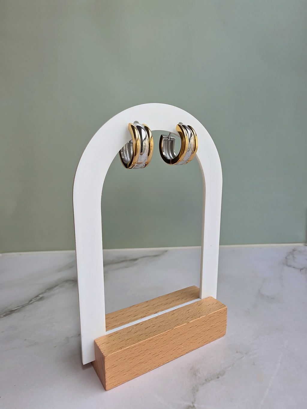 Stylish non tarnish huggie earrings with a two-tone design.