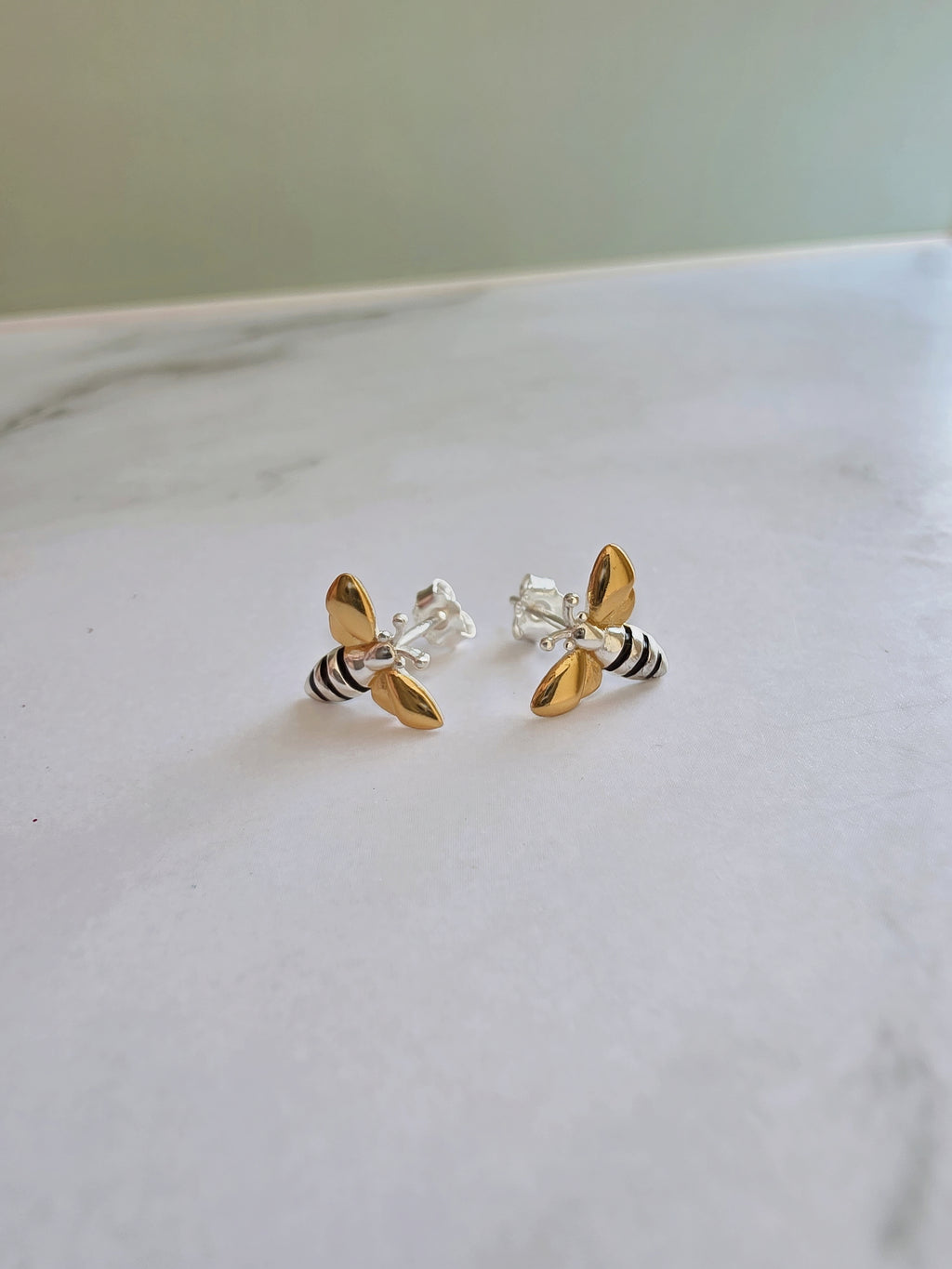 Dainty bee earrings for women.