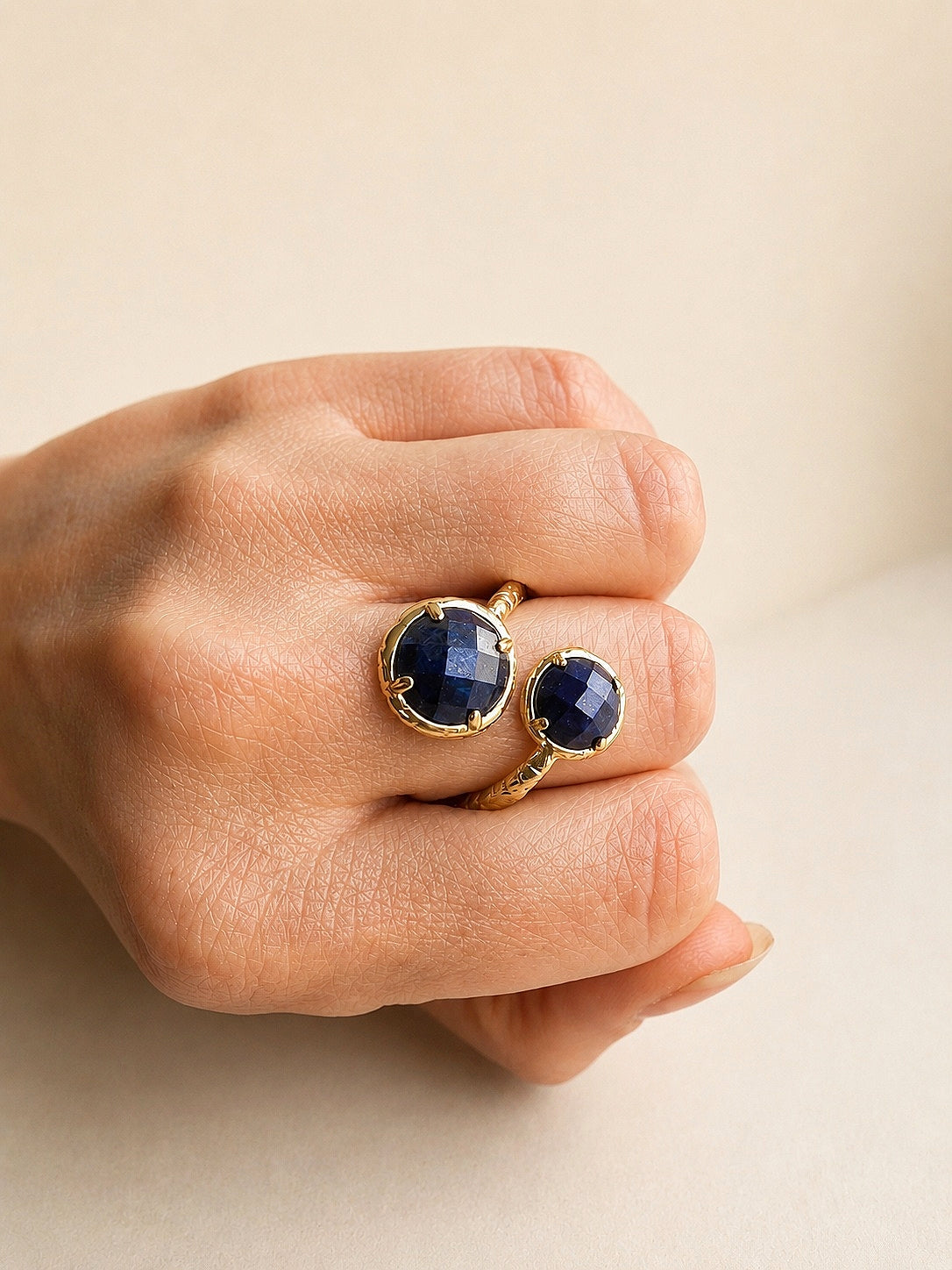 Adjustable lapis lazuli ring with gold setting.