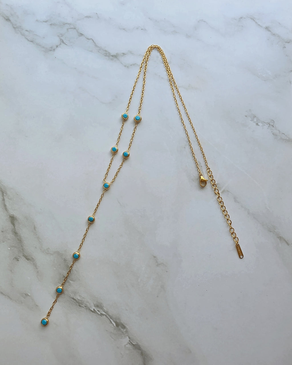 Gold turquoise Y necklace with delicate blue beads.