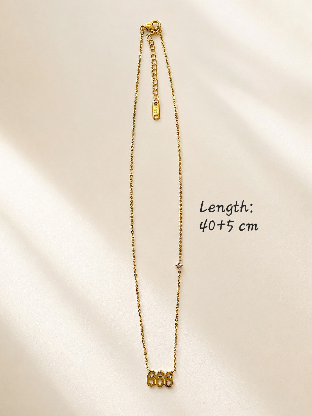 Gold angel number necklace featuring 666 pendant for everyday wear.
