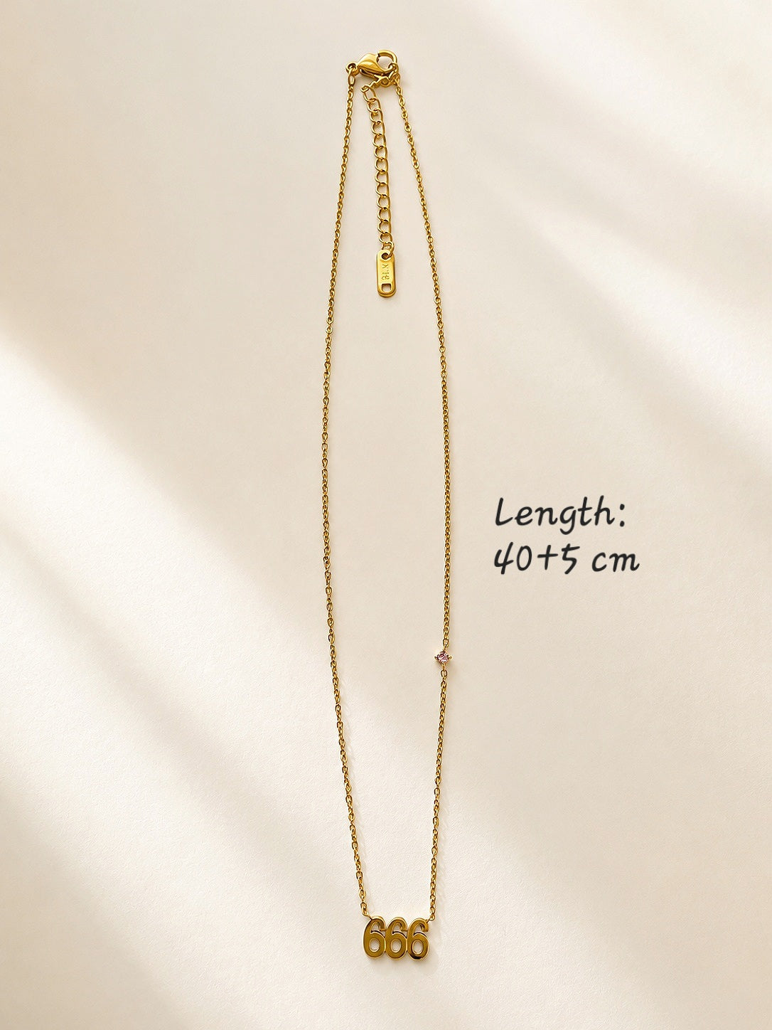 Gold angel number necklace featuring 666 pendant for everyday wear.