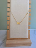 Minimalist number necklace with 111 pendant on a delicate gold chain.