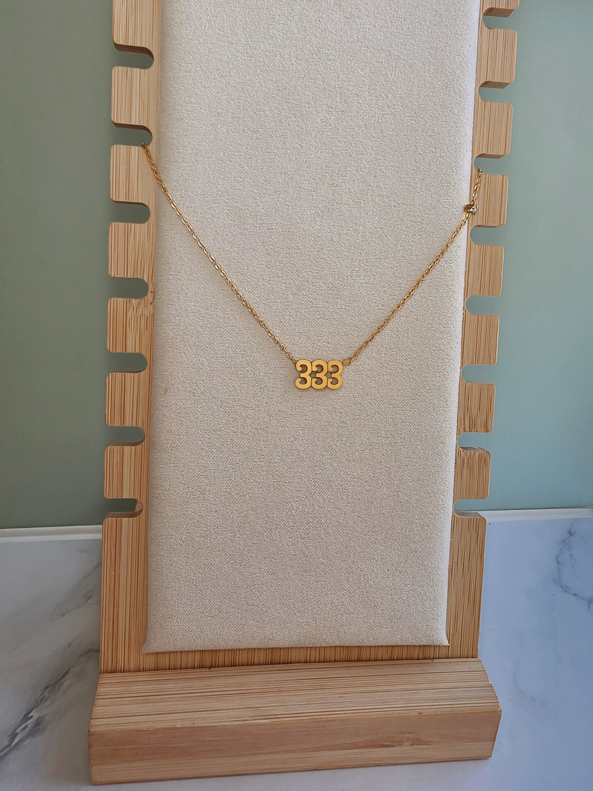 18K gold plated 333 necklace with non-tarnish finish.