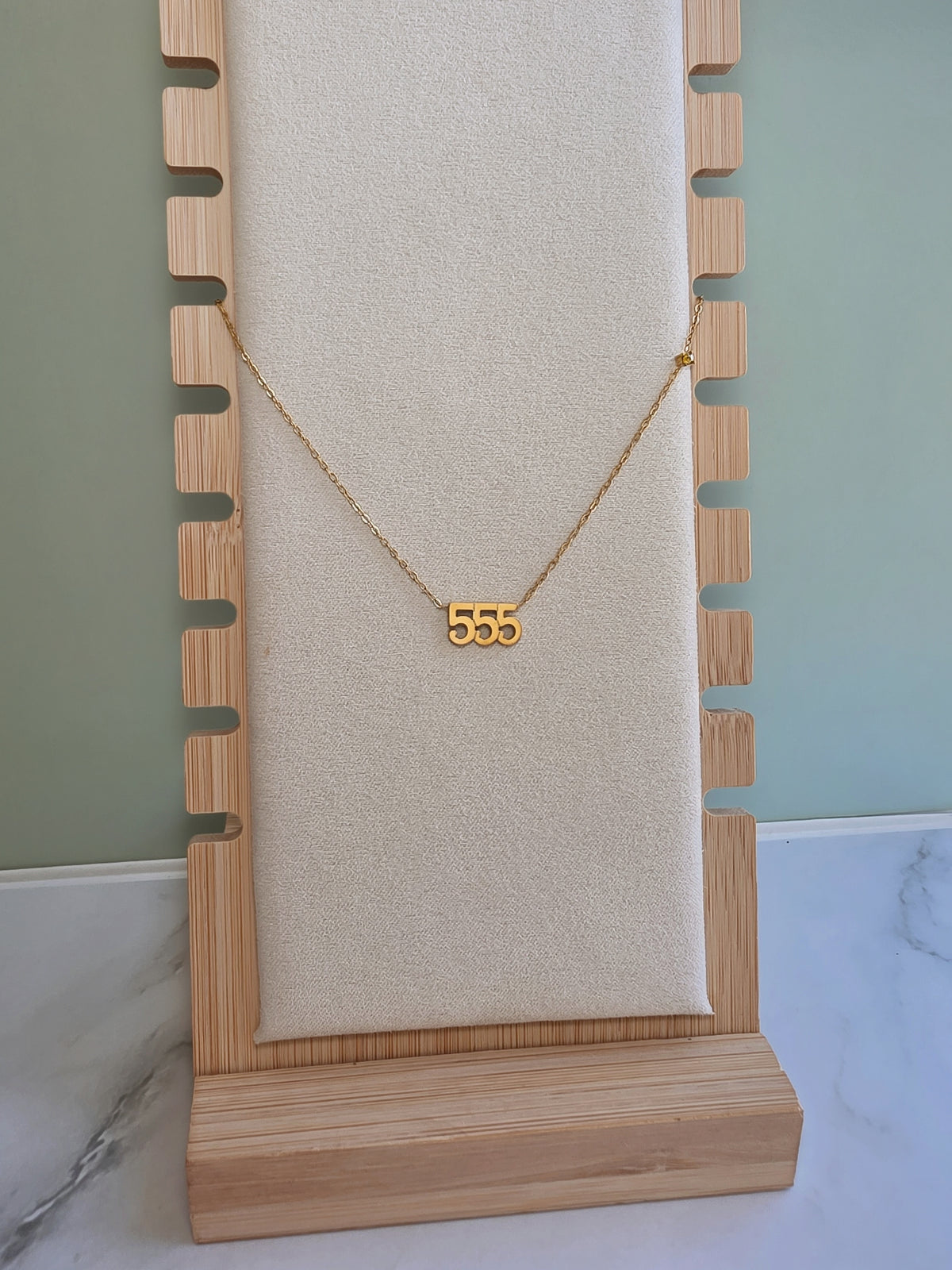 Delicate gold number necklace perfect for layering with other jewelry.