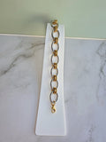 Statement paperclip bracelet in two-tone finish.
