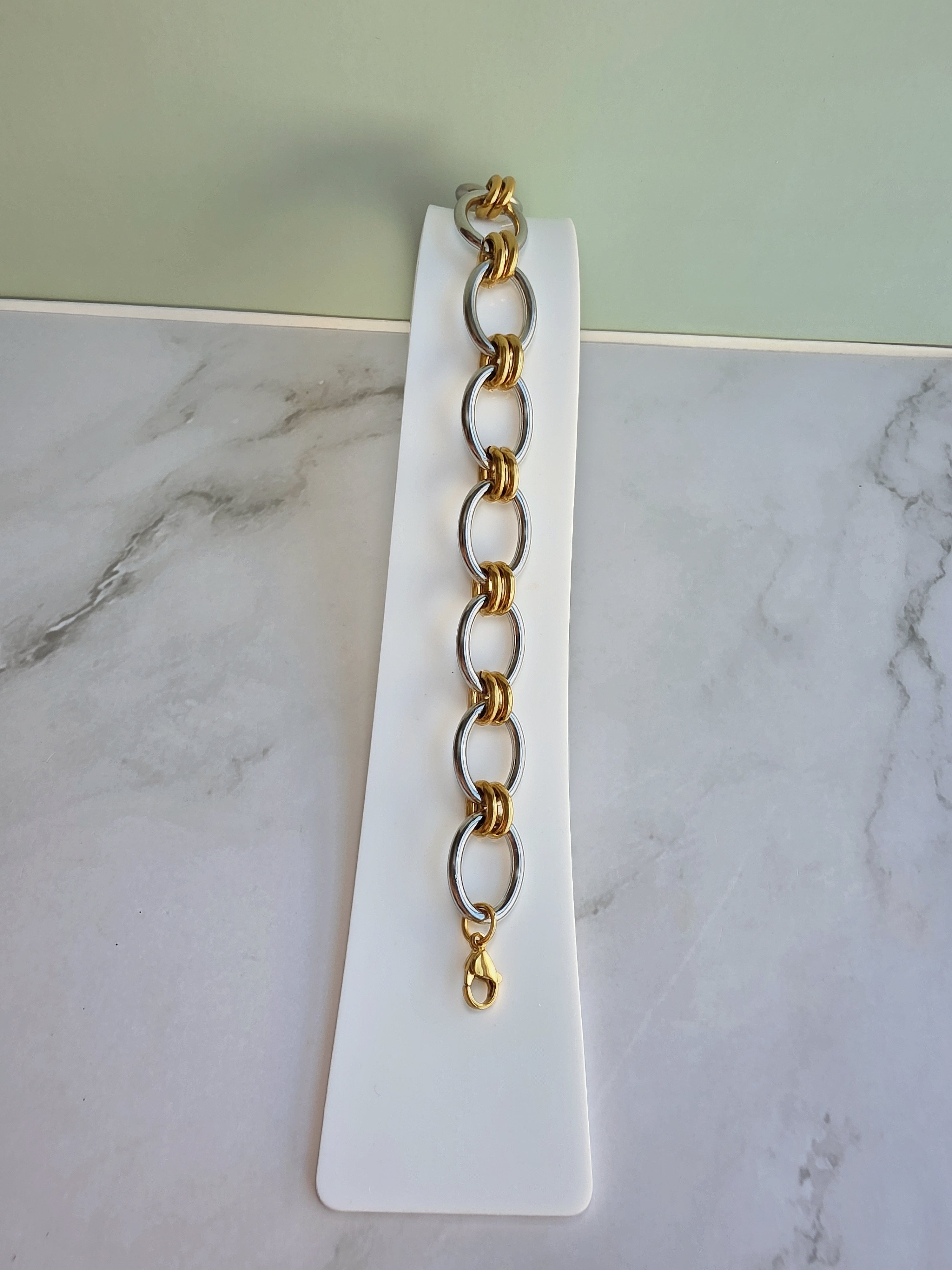 Statement paperclip bracelet in two-tone finish.