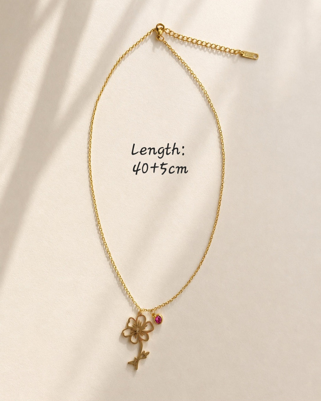 Botanical birth flower necklace with a colorful birthstone accent.