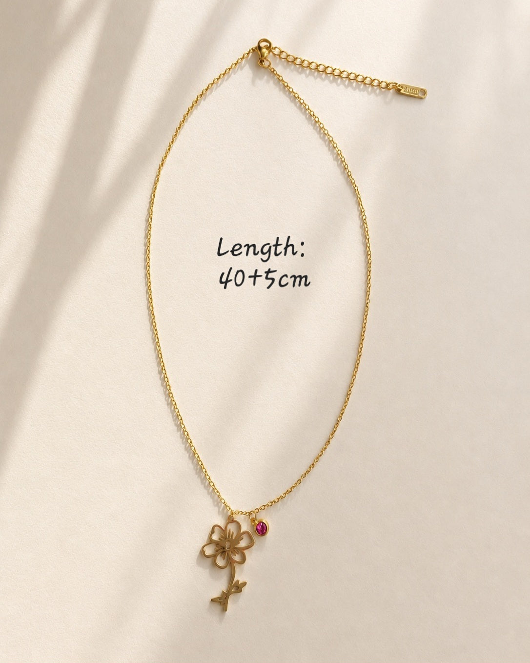 Botanical birth flower necklace with a colorful birthstone accent.