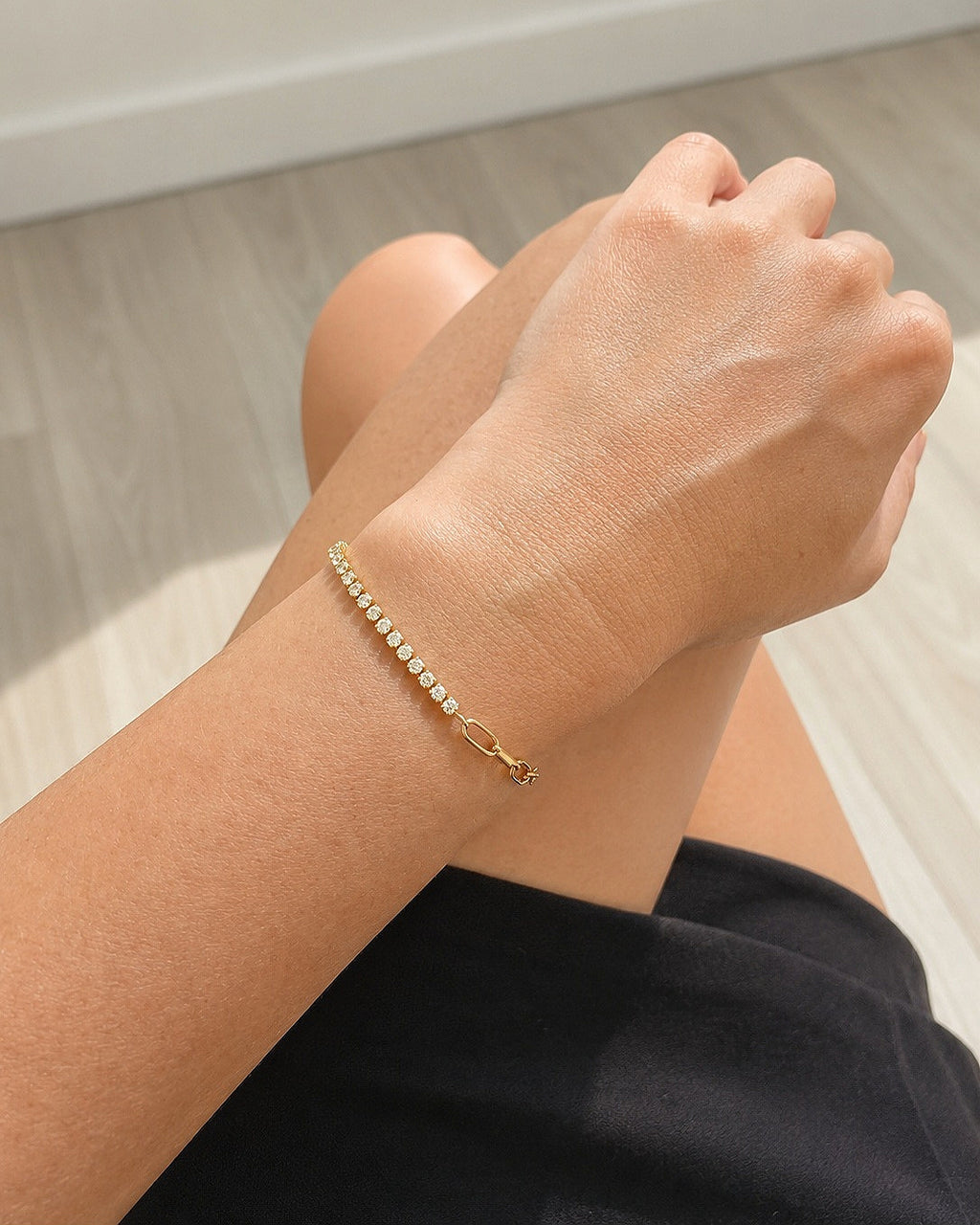 Paperclip gold tennis bracelet with sparkling cubic zirconia.