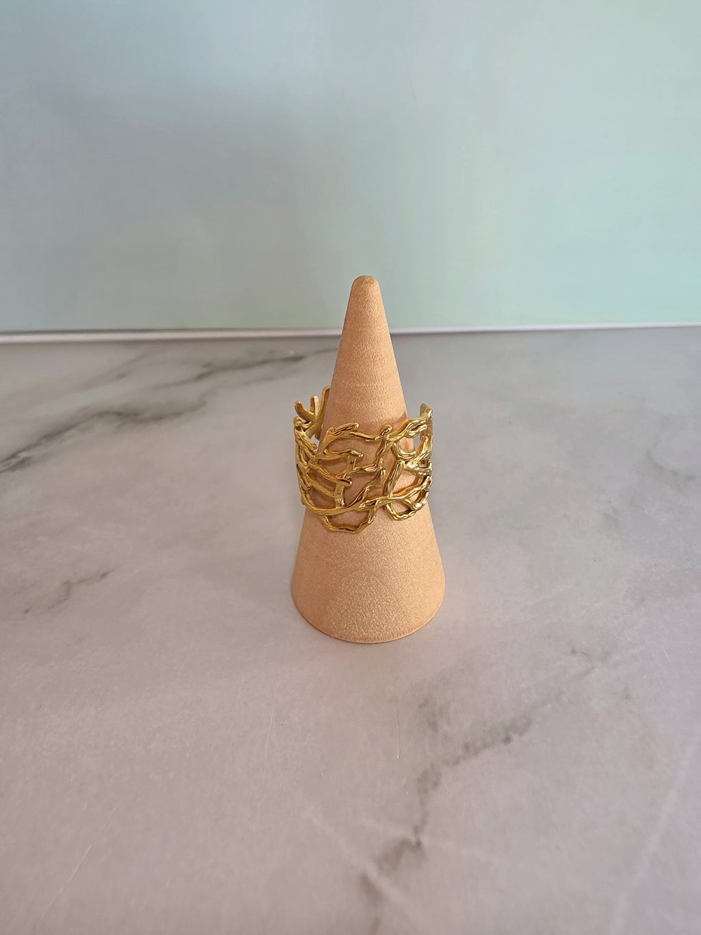 Women's molten gold ring with a bold sculptural statement style.