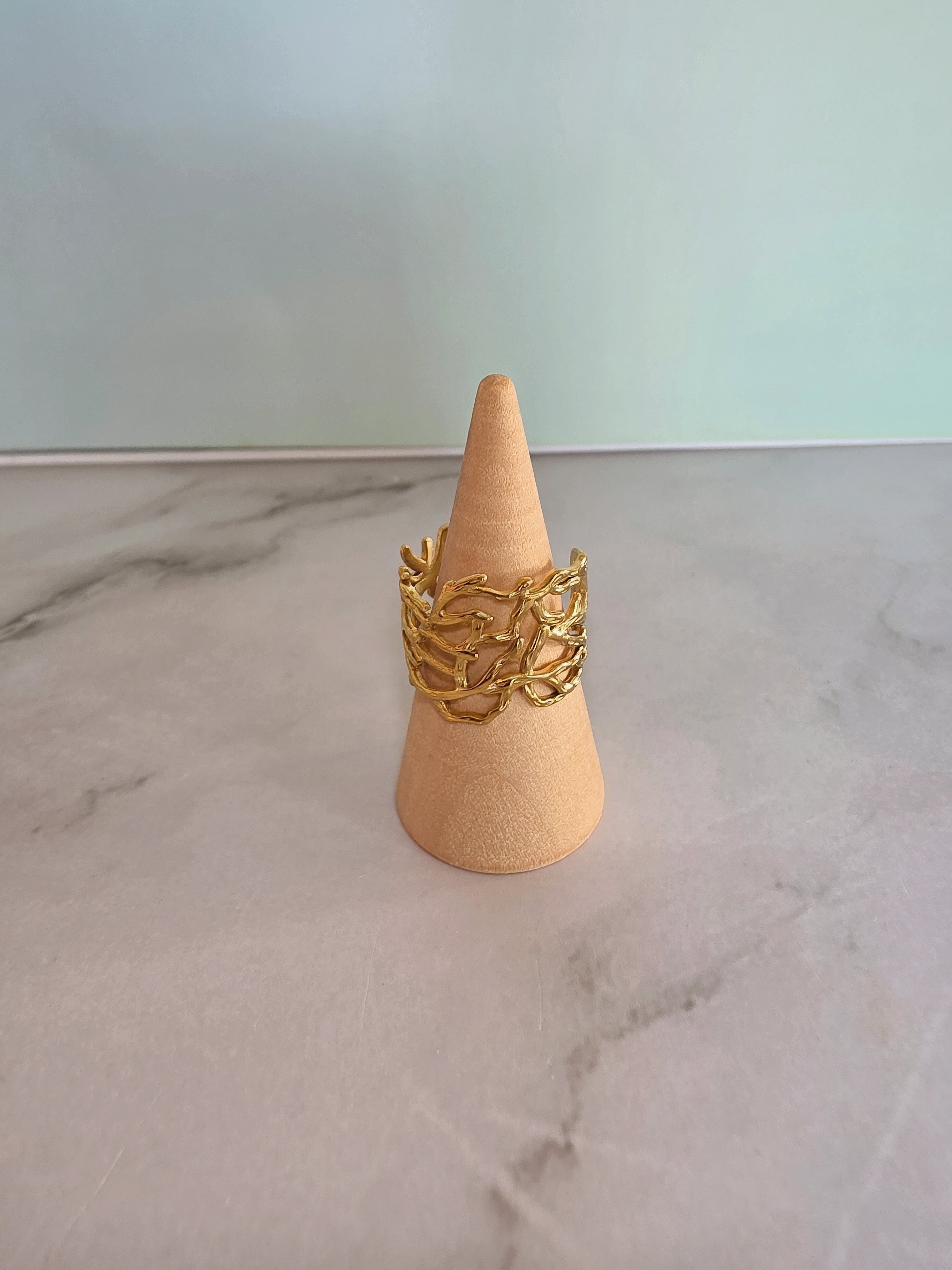 Women's molten gold ring with a bold sculptural statement style.