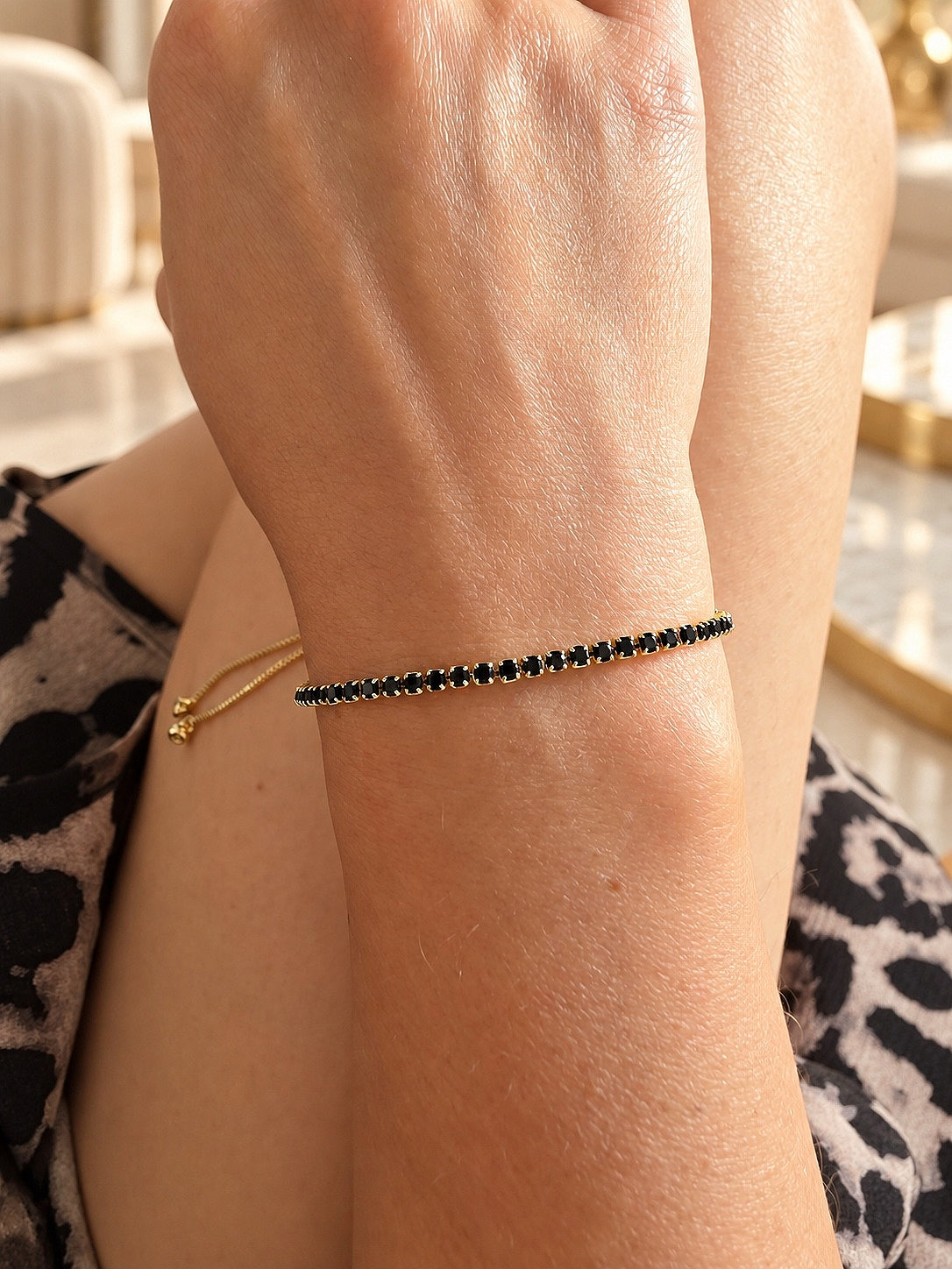 Black onyx tennis bracelet with gold plated brass setting