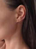 Elegant gold ear crawler earrings featuring a modern hammered texture.