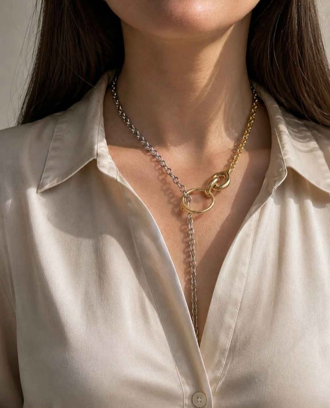 Elegant mixed metal chain necklace with a modern toggle clasp.