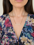 Ocean wave necklace in gold and silver finishes.