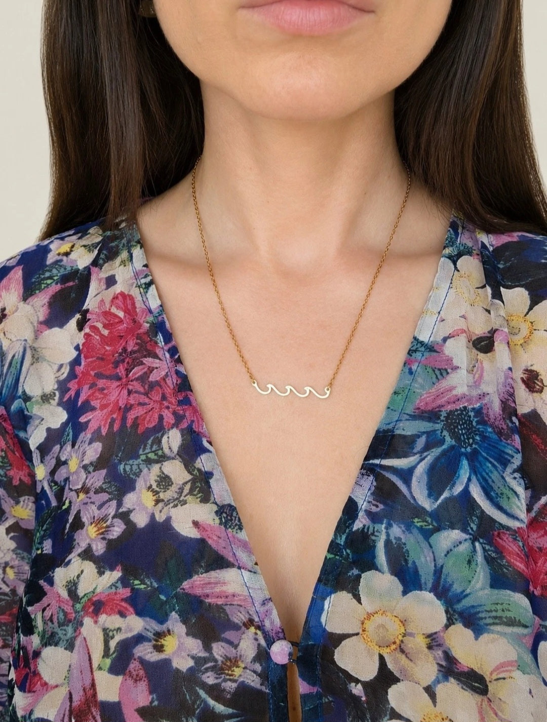 Ocean wave necklace in gold and silver finishes.