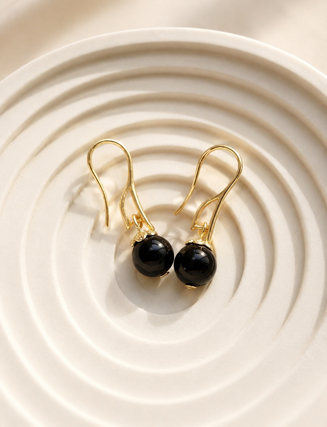 Black onyx, lapis lazuli, and red agate gemstone drop earrings in gold and silver finishes.