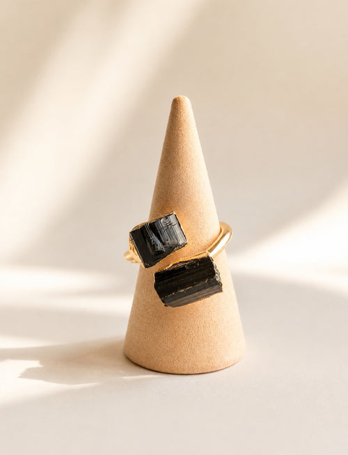Adjustable black tourmaline statement ring with a polished gold-plated band.