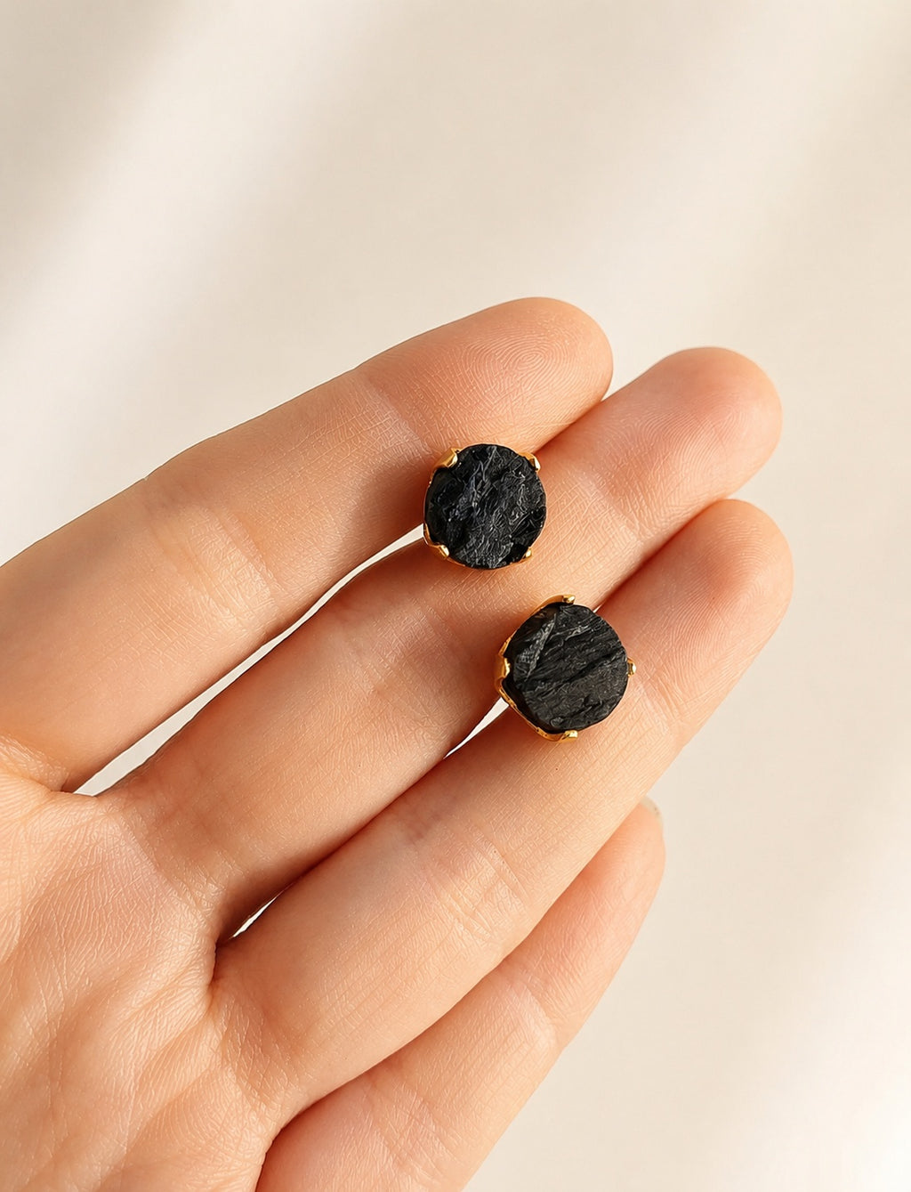 Black tourmaline stud earrings with natural raw crystals and 18K gold plating.