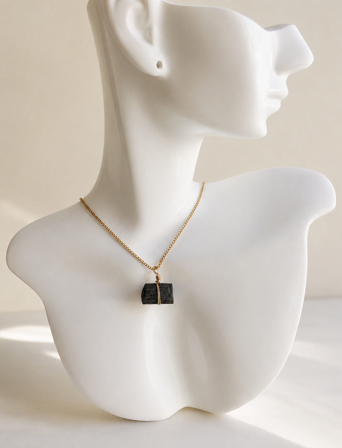 Black tourmaline necklace with a natural raw crystal pendant and 18K gold-plated chain.