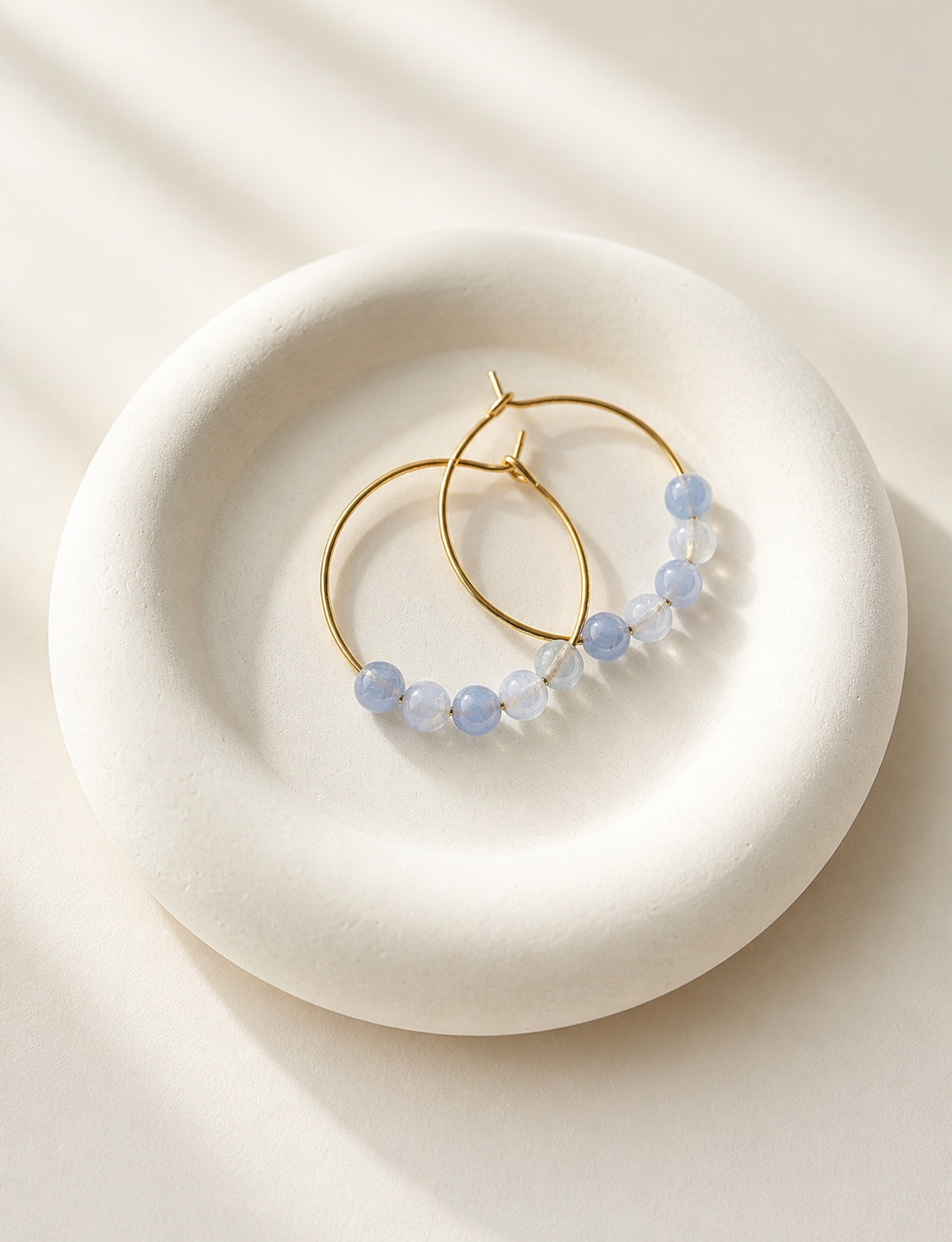Aquamarine beaded hoop earrings with 18K gold-plated hoops and natural blue gemstones.