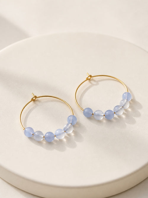 March birthstone hoop earrings featuring polished aquamarine beads and gold hoops.