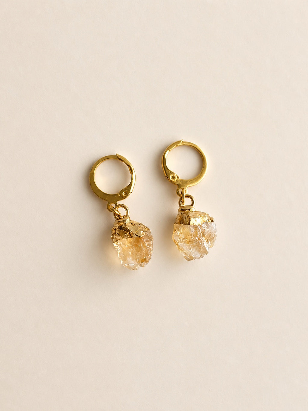 Minimalist raw crystal hoop earrings available in aquamarine, citrine, moonstone, and peridot.
