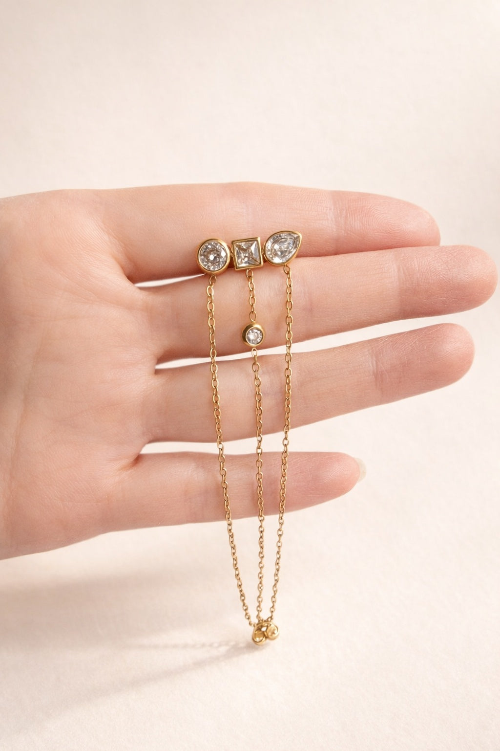 18K gold-plated stainless steel geometric dangle earrings with cascading chain details.