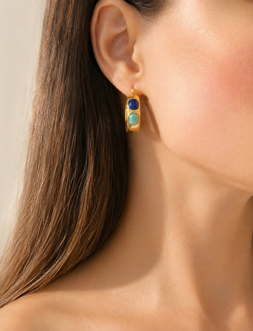 Bold gold hoop earrings featuring deep blue lapis lazuli statement stones.