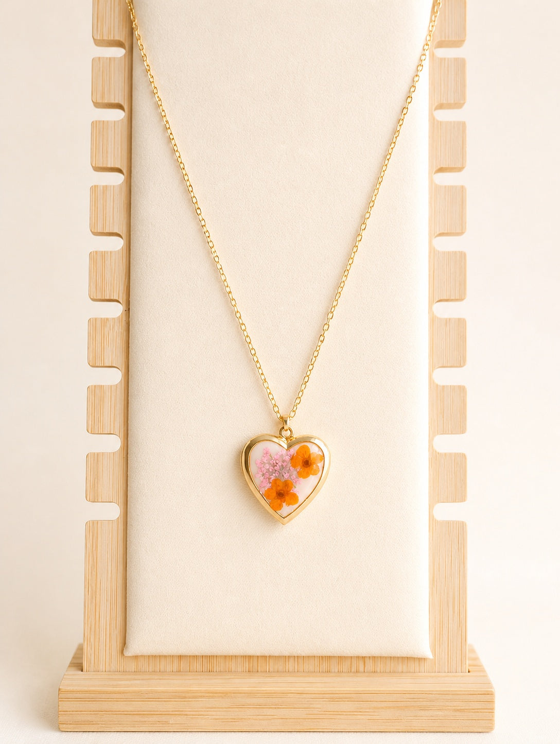 Real flower heart necklace available in gold and silver finishes.