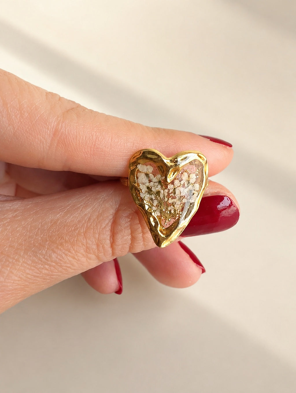 Pressed flower resin heart ring with real dried flowers and 18K gold-plated finish.
