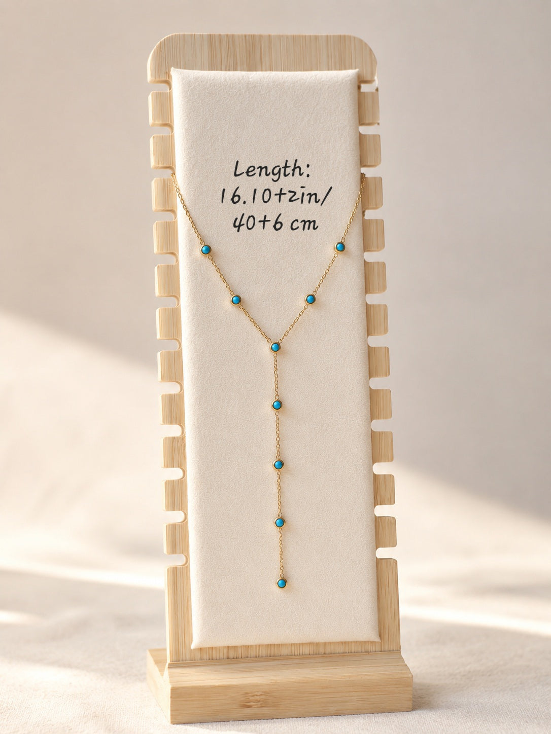 Adjustable turquoise Y necklace on gold chain.