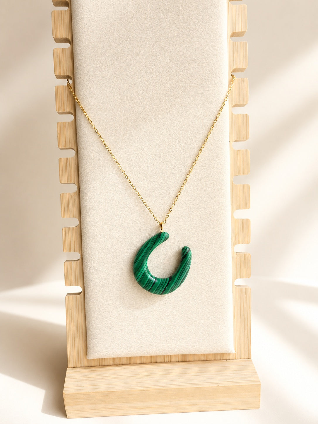 Malachite horseshoe necklace with an 18K gold-plated chain.